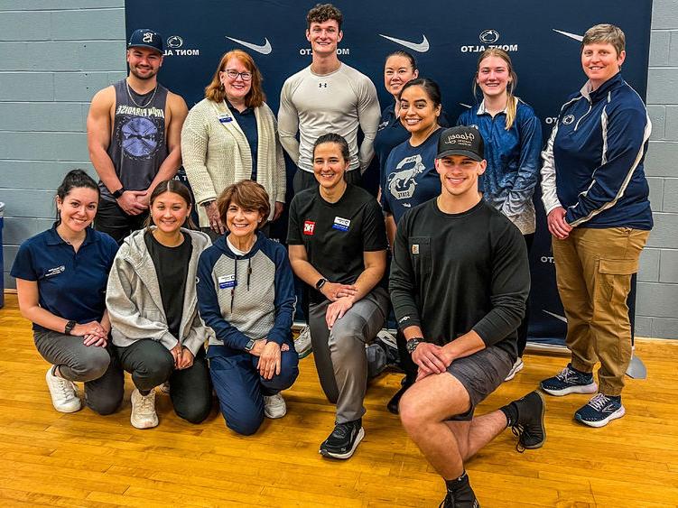 Group photo of faculty and students in front of Penn State Mont Alto athletics banner after the Functional Movement Screen.